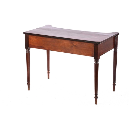 274 - A Regency style mahogany concave front side table, the top with rounded corners over a frieze drawer... 