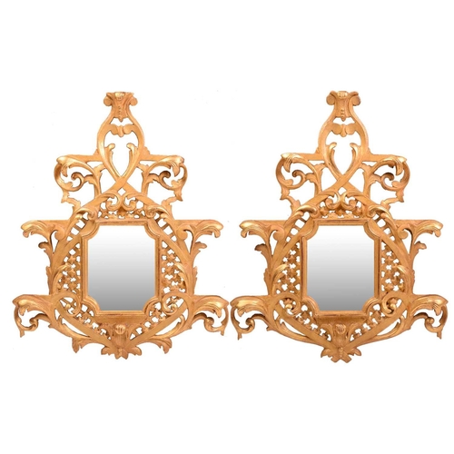 277 - A pair of George II style giltwood wall mirrors, the rectangular plates with concave corners within ... 