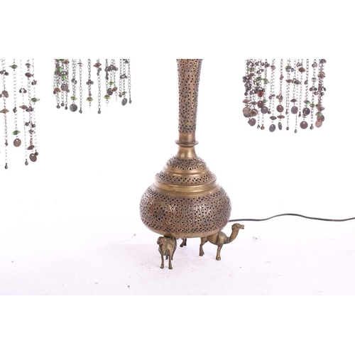 282 - A pair of brass Moroccan table lamps, with pierced and engraved decoration and applied with a silver... 