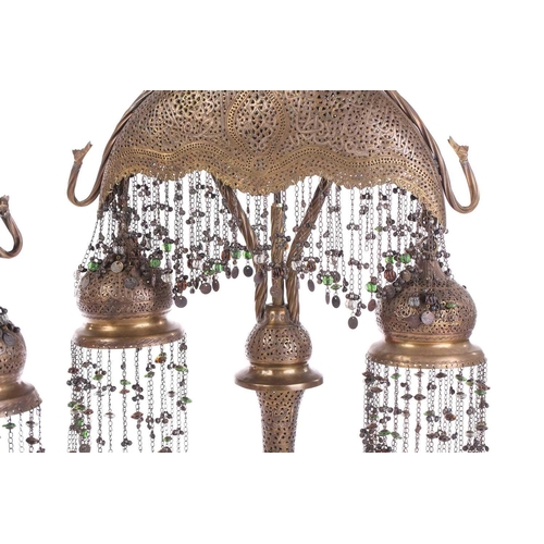 282 - A pair of brass Moroccan table lamps, with pierced and engraved decoration and applied with a silver... 