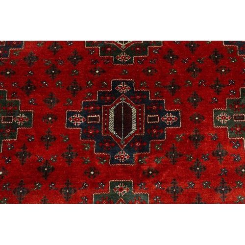 297 - A large dark red ground Turkomen-style carpet, 20th century with cruciform guls within geometric bor... 