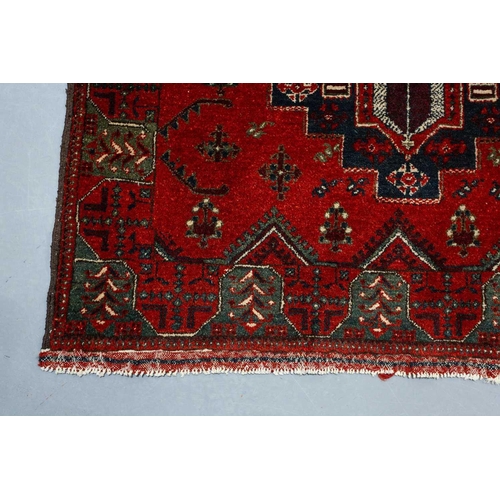 297 - A large dark red ground Turkomen-style carpet, 20th century with cruciform guls within geometric bor... 