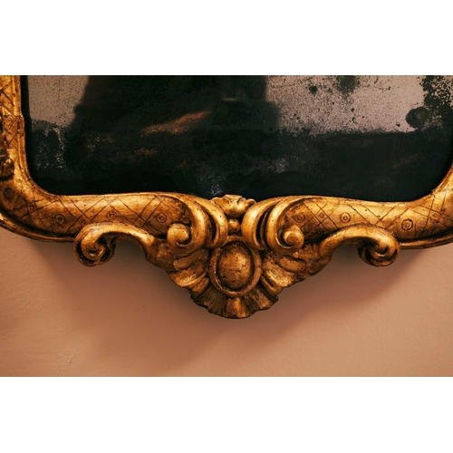 3 - An 18th-century French giltwood wall mirror, 97 x 49 cm, the plate 67 cm x 36.5 cm, (re-gilt and res... 