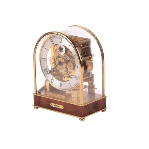 303 - A Kieninger 8-day contemporary mantel clock, with brass arched and glazed case, with skeletal dial c... 