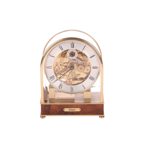 303 - A Kieninger 8-day contemporary mantel clock, with brass arched and glazed case, with skeletal dial c... 