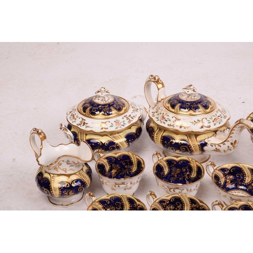 331 - An early 19th-century porcelain tea service, in the manner of Derby or Coalport, with exotic bird an... 