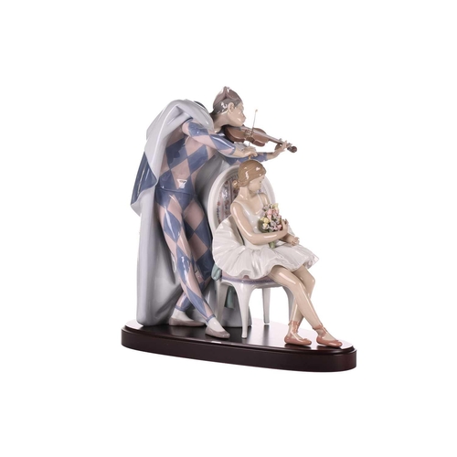 334 - A large Lladro figure, 'Jester's Serenade', modelled as a ballerina with bouquet of flowers seated b... 