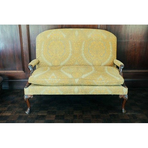 34 - A George III small settee, with upholstered rectangular back, Tudor rose carved mahogany arm support... 