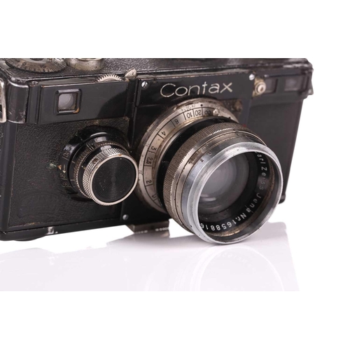 349 - A Zeiss Ikon Contax 35mm rangefinder camera, contained in a vintage leather case, with assorted acce... 