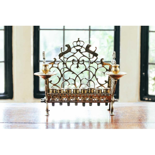 41 - An 18th century Dutch/German brass menorah, with row of eight sconces and side lights, fretwork back... 