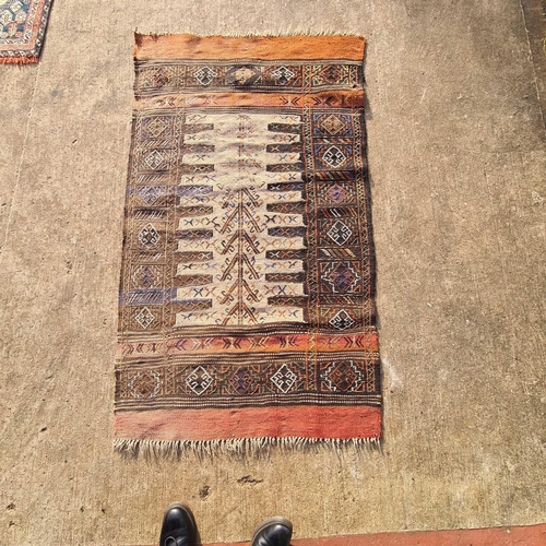 48 - A red ground antique Tekke Turkoman rug, 160 cm x 116 cm, together with three soumak worked jaijim m... 