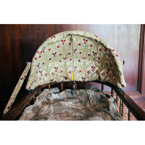 57 - An oak spindle frame child's cot, 19th century, with fitted drapery, 108 cm long x 49 cm wide x 80 c... 