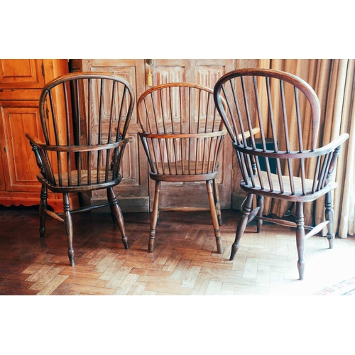 60 - Two similar ash and elm Windsor armchairs, spindle back, baluster turned supports; and another spind... 