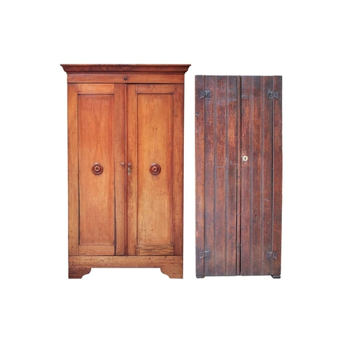 69 - A Victorian mahogany twin door cupboard, the cavetto moulded cornice with a single roundel applied f... 