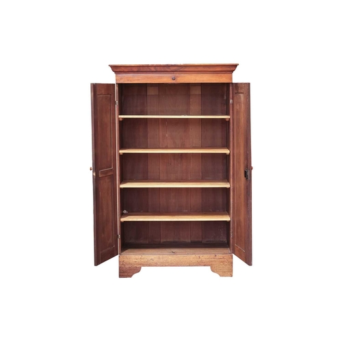 69 - A Victorian mahogany twin door cupboard, the cavetto moulded cornice with a single roundel applied f... 