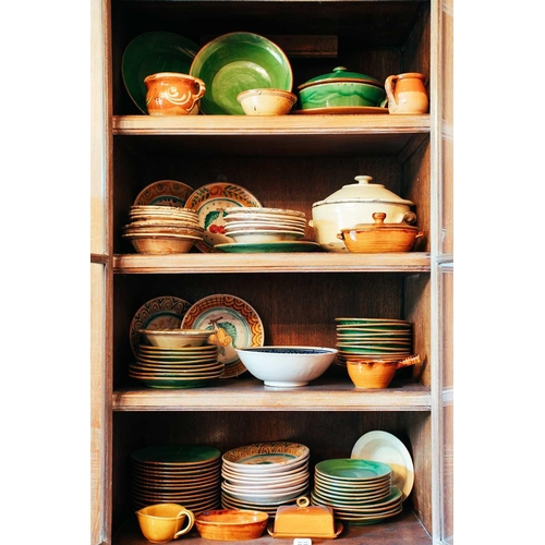 75 - A large collection of rustic tin-glazed kitchen pottery, to include plates, bowls, tureens, covered ... 