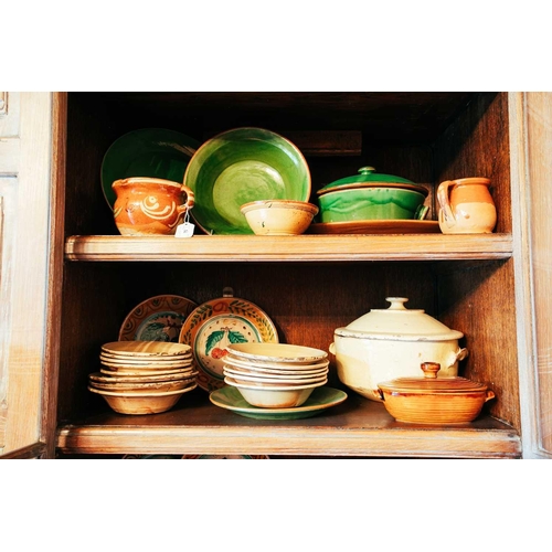 75 - A large collection of rustic tin-glazed kitchen pottery, to include plates, bowls, tureens, covered ... 