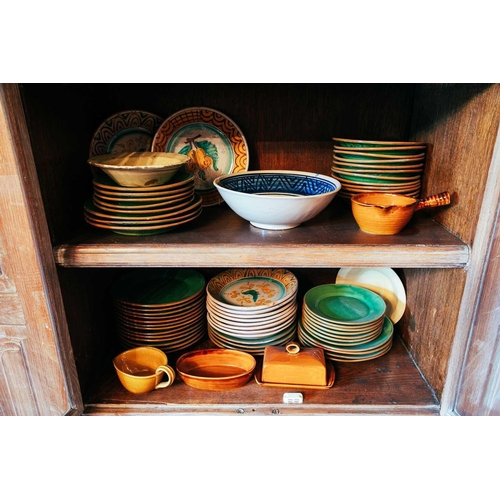 75 - A large collection of rustic tin-glazed kitchen pottery, to include plates, bowls, tureens, covered ... 