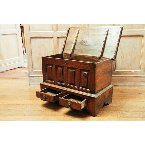 78 - An 18th century Welsh coffer bach, the hinged top above a panel front and two short drawers, 48 cm h... 