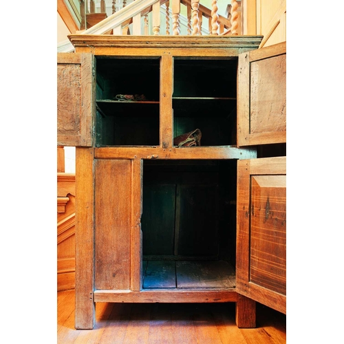 8 - A 19th-century French oak two-door cupboard, the moulded cornice above a panelled door over a furthe... 