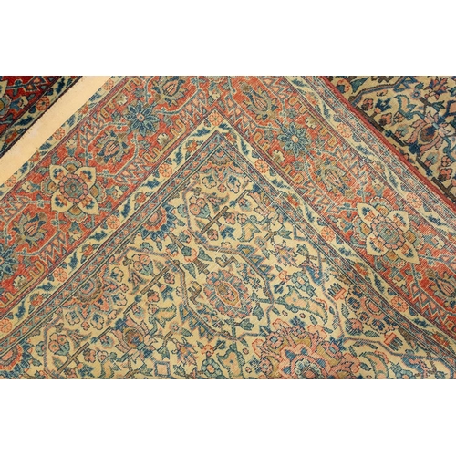 24 - An antique ivory ground Kerman rug with an allover floral design within multiple borders 202 x 137cm... 