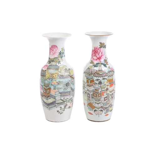 245 - A pair of Chinese famille rose baluster vases, depicting vases of chrysanthemums, books, bowls of fr... 