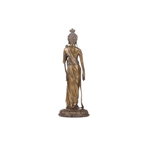 257A - After Takamura Koun, a gilt bronze figure of Kannon with lotus sceptre in the standing teaching mudr... 