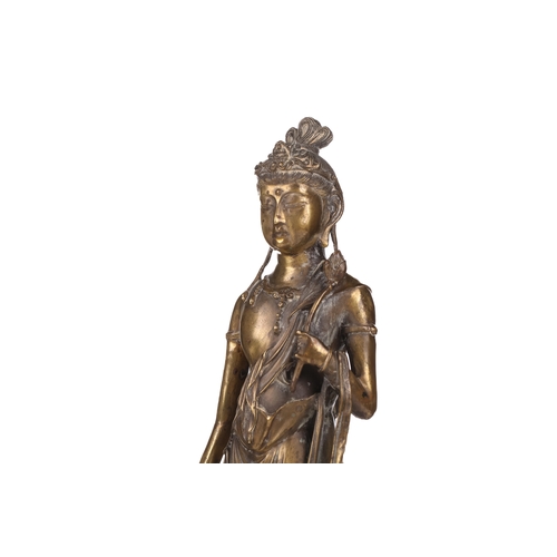 257A - After Takamura Koun, a gilt bronze figure of Kannon with lotus sceptre in the standing teaching mudr... 