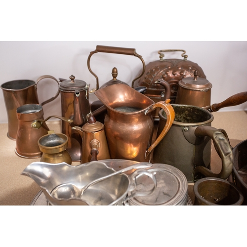 77 - A large quantity of brass, pewter and copper items, to include pans, bowls, a milk churn, candlestic... 