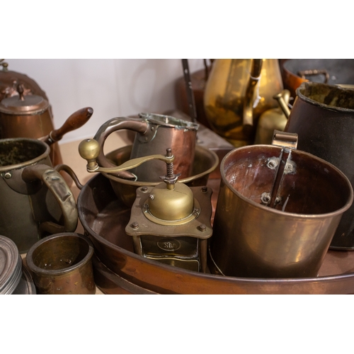 77 - A large quantity of brass, pewter and copper items, to include pans, bowls, a milk churn, candlestic... 