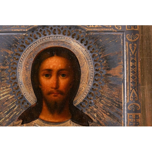 246 - A Russian Christ Pantocrator icon, late 19th century, with pierced and engraved and gilt white metal... 