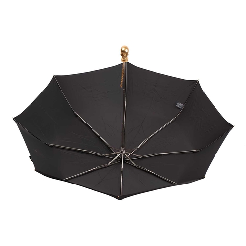 Alexander McQueen - a black folding umbrella with gold-tone skull
