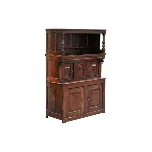 176 - An 18th century Wesh oak Cwpwrdd Tridarn cupboard with open hutch top over a middle tier of shaped p... 