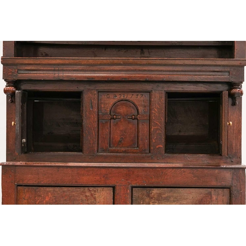 176 - An 18th century Wesh oak Cwpwrdd Tridarn cupboard with open hutch top over a middle tier of shaped p... 