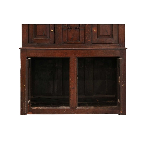 176 - An 18th century Wesh oak Cwpwrdd Tridarn cupboard with open hutch top over a middle tier of shaped p... 