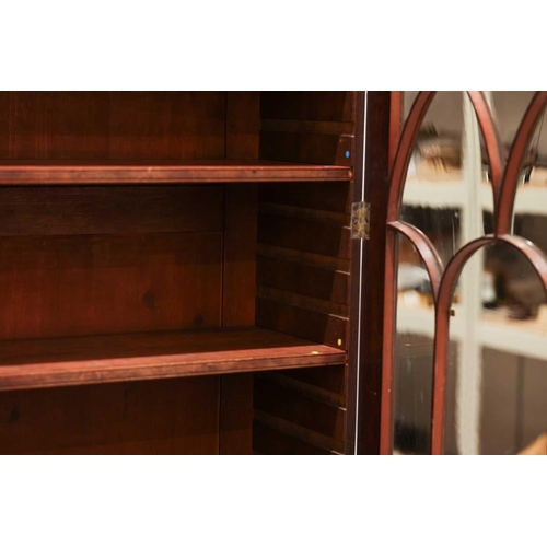 183 - A George IV mahogany secretaire bookcase, the upper section with a pair of eliptical glazed doors, t... 