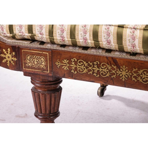 192 - In the manner of John McLean a Regency brass inlaid rosewood double scroll chaise longue, with spent... 