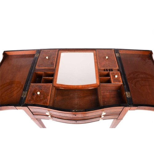 195 - A George III figured satinwood serpentine dressing table with two flap top opening to reveal a fitte... 