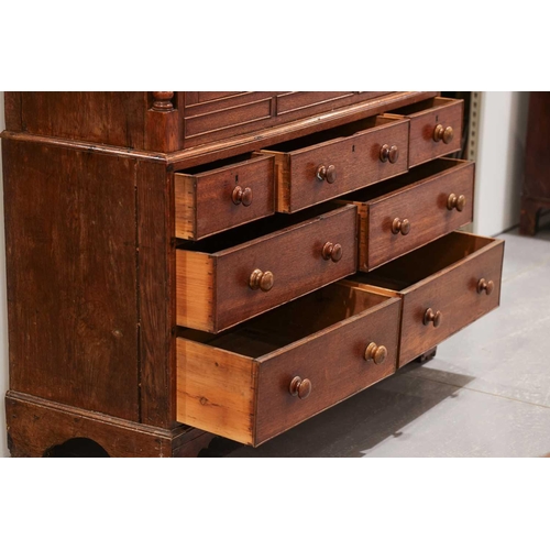 205 - An early 19th century Welsh (Carmarthenshire) oak linen press cupboard, with a pair of double panel ... 