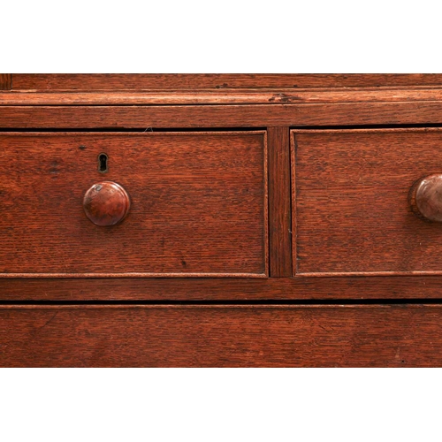 205 - An early 19th century Welsh (Carmarthenshire) oak linen press cupboard, with a pair of double panel ... 