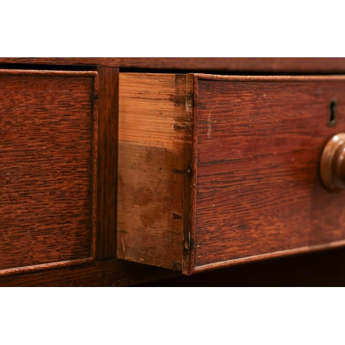 205 - An early 19th century Welsh (Carmarthenshire) oak linen press cupboard, with a pair of double panel ... 