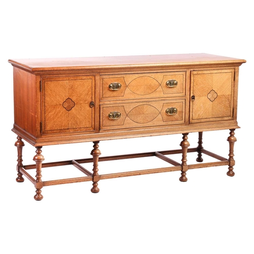 209 - A Morgan and Co. arts and crafts oak sideboard with strung detail to the doors, raised on turned tru... 