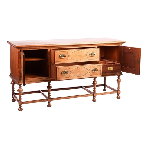 209 - A Morgan and Co. arts and crafts oak sideboard with strung detail to the doors, raised on turned tru... 