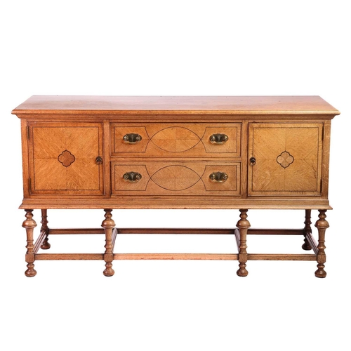 209 - A Morgan and Co. arts and crafts oak sideboard with strung detail to the doors, raised on turned tru... 