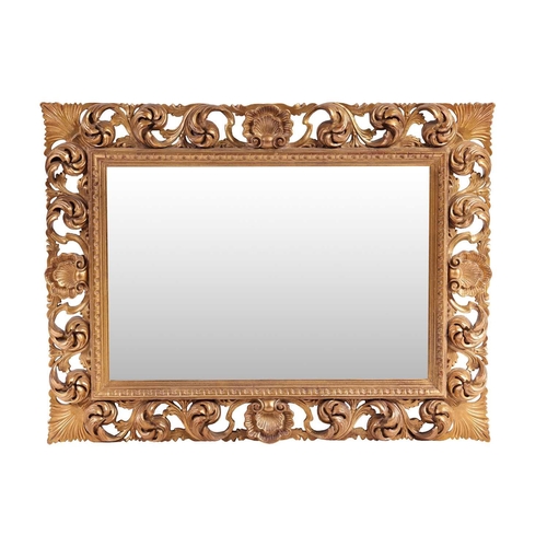 213 - An 18th-century style heavy framed rectangular wall mirror with carved pierced and gilt scrolled sur... 