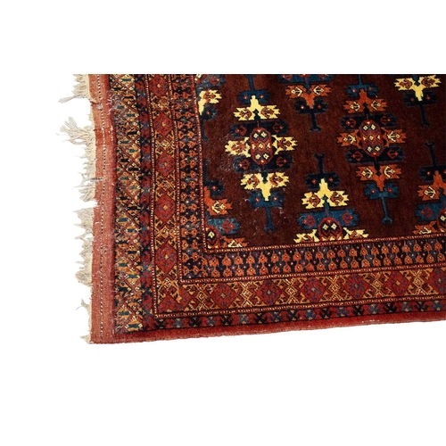 216 - A red ground Turkoman rug with rows of composite guls within reciprocal arrow head borders, 172 cm x... 