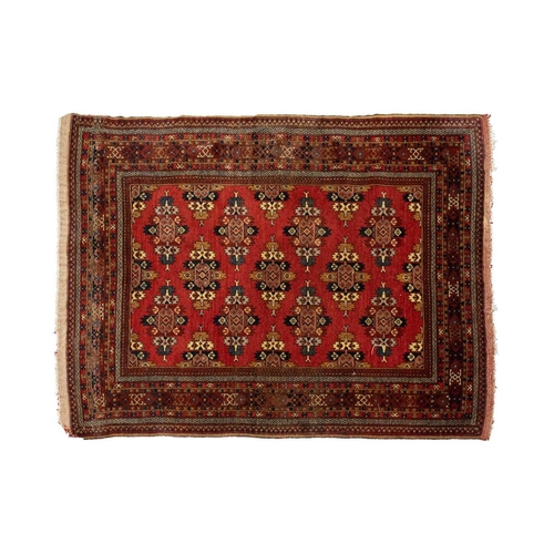 216 - A red ground Turkoman rug with rows of composite guls within reciprocal arrow head borders, 172 cm x... 