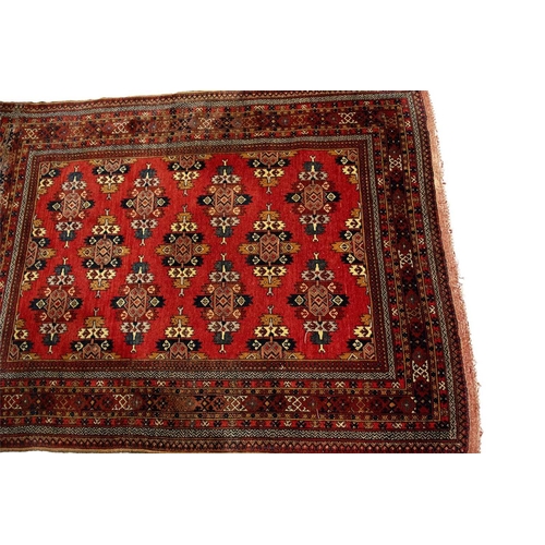 216 - A red ground Turkoman rug with rows of composite guls within reciprocal arrow head borders, 172 cm x... 