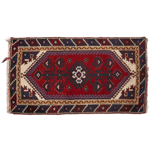 216 - A red ground Turkoman rug with rows of composite guls within reciprocal arrow head borders, 172 cm x... 