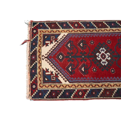 216 - A red ground Turkoman rug with rows of composite guls within reciprocal arrow head borders, 172 cm x... 